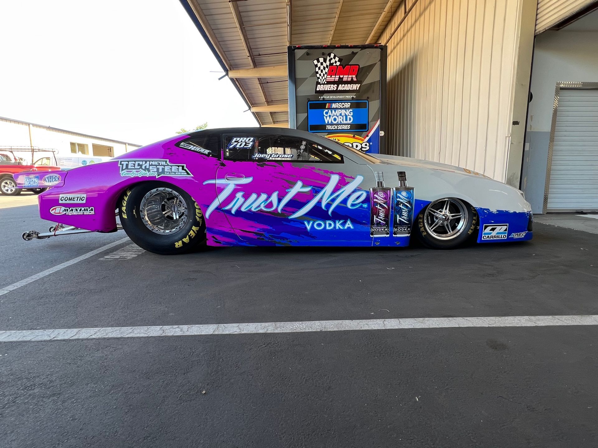 a purple and blue race car that says trust me vodka