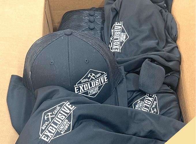 a box filled with shirts and hats that say exclusive