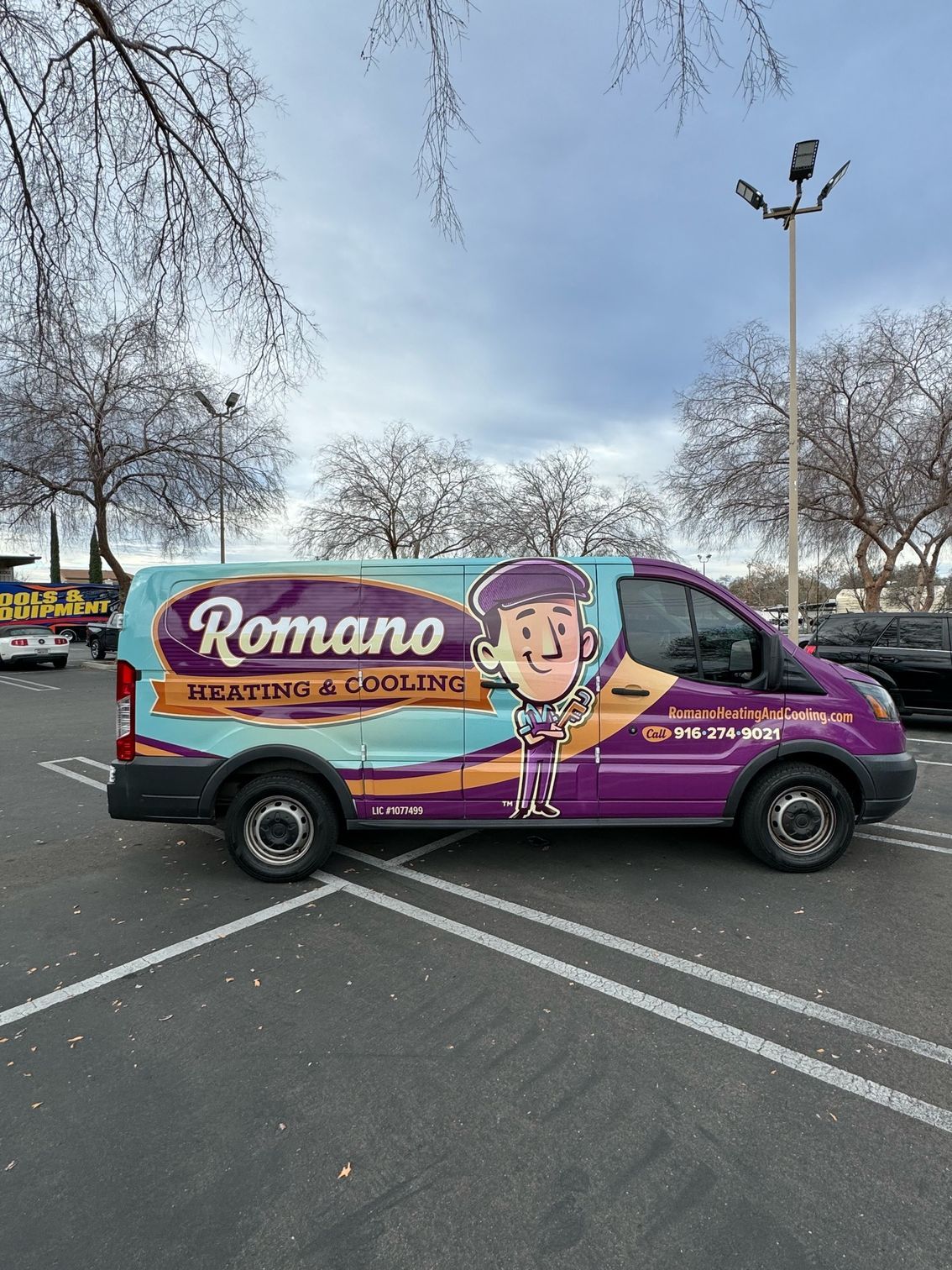 a purple van is parked in a parking lot .