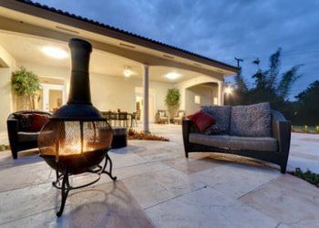 Outdoor fire place, patio heater on marble paved outdoor patio