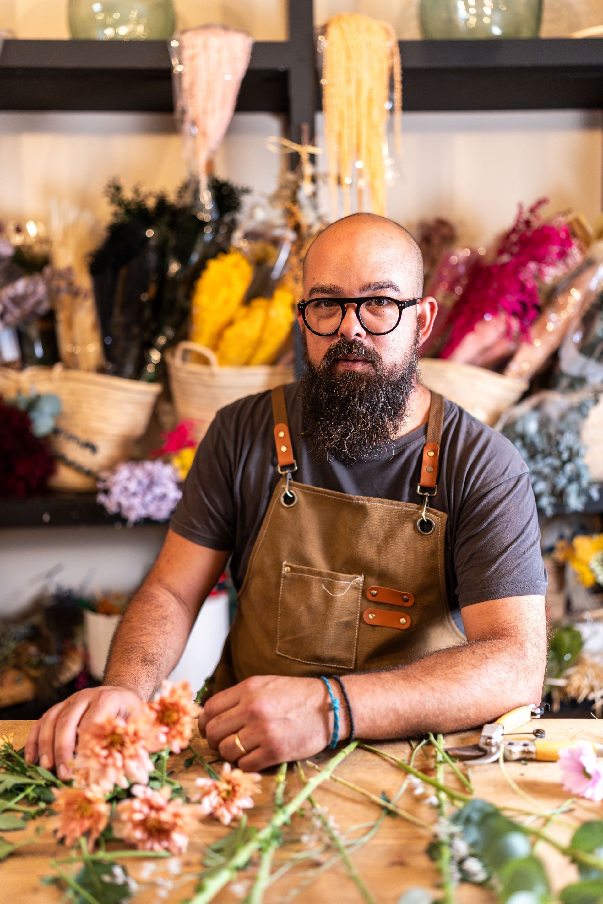 A woman reviews documents with a couple at a table, likely a business meeting.