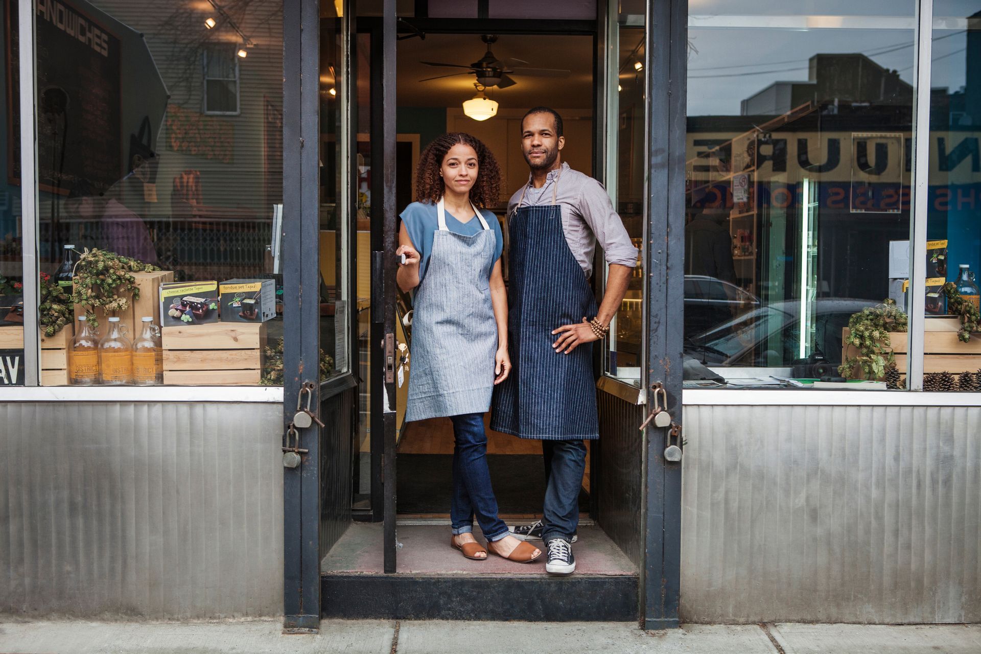 Woman on crutches shakes hands with another person, with others nearby.