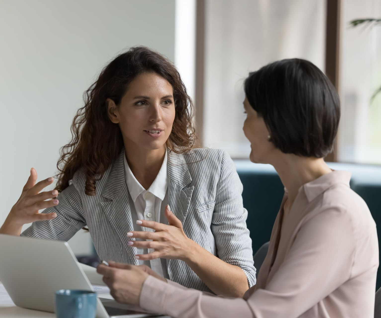 Family makes a home with arms: parents with a child smiling on a rug in a living room.
