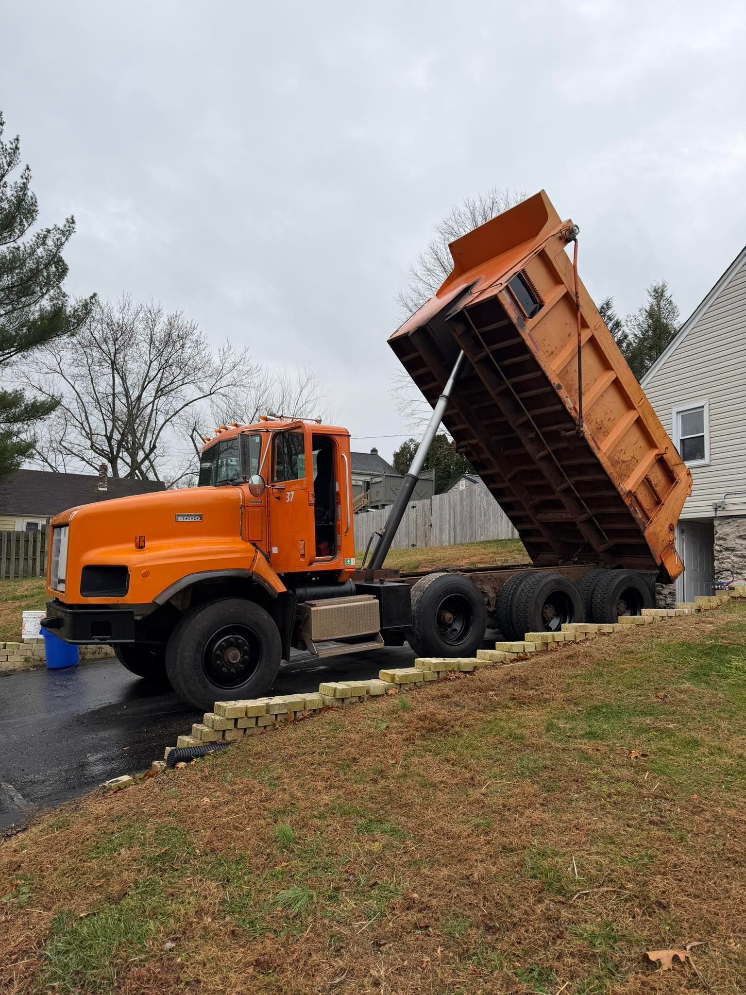 A house is being demolished by a crane.