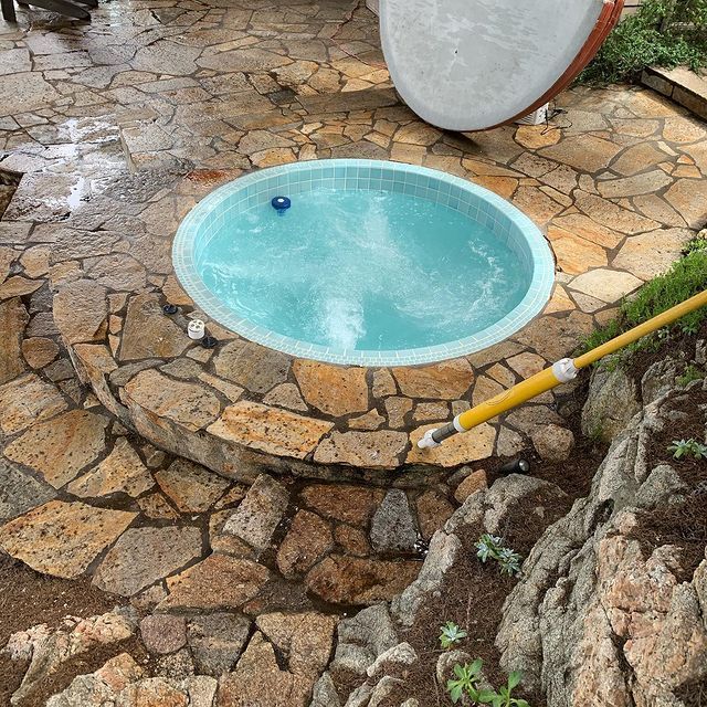 A round pool with a blue ball in it