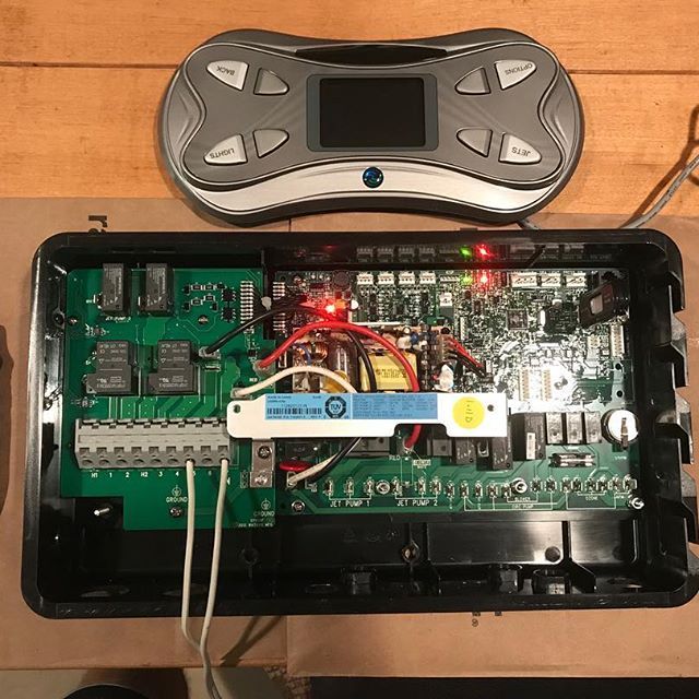 The inside of a device with a remote control on top of it