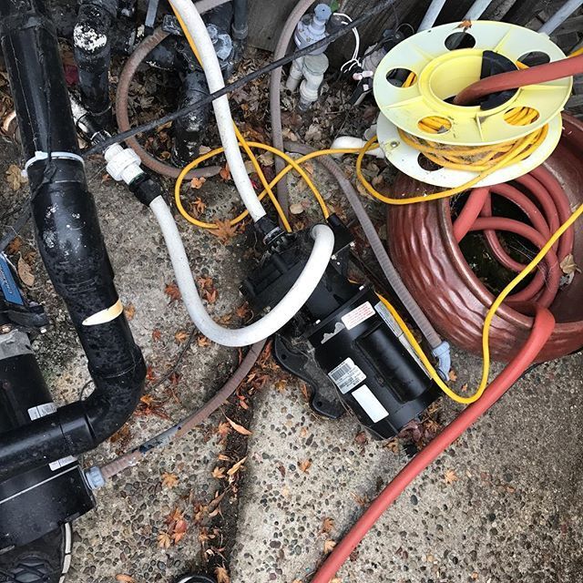 A bunch of wires and pipes are laying on the ground