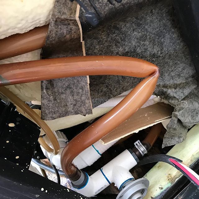 A bunch of pipes and wires are laying on the ground