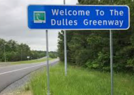 A large, white-pillared historic brick mansion viewed from the bottom of stone steps surrounded by evergreen bushes.