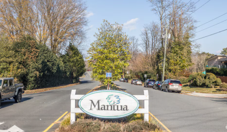 An oval community entrance sign reading An oval community entrance sign reading