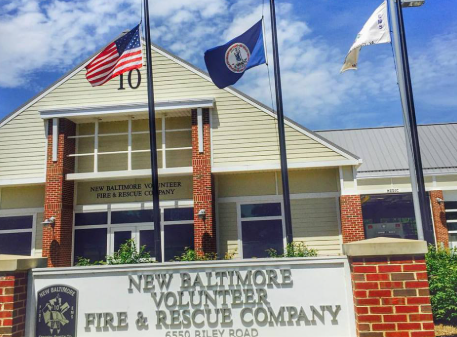 New Baltimore Volunteer Fire & Rescue Company building with flags flying above the entrance