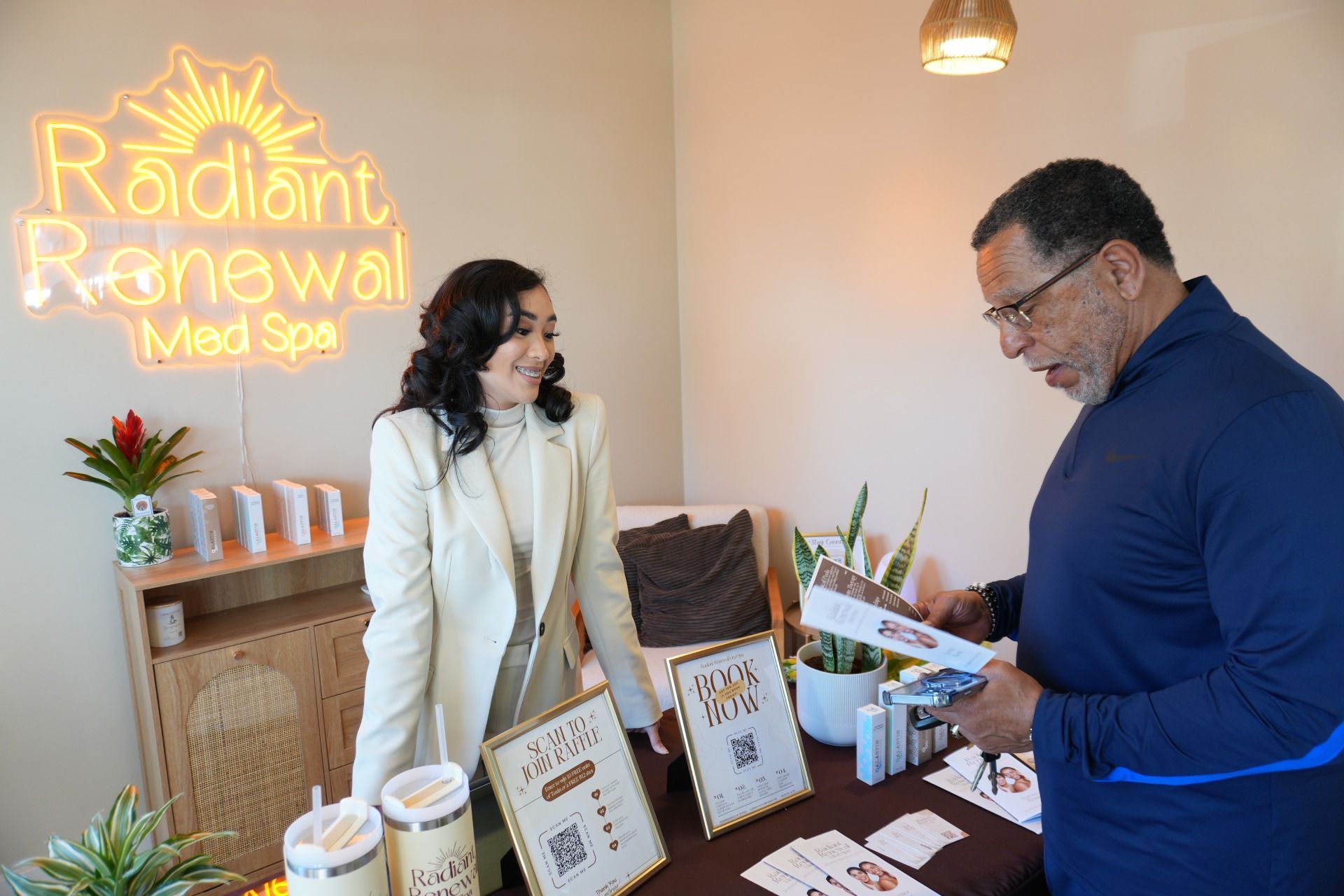 A man and a woman are standing next to each other in a room.