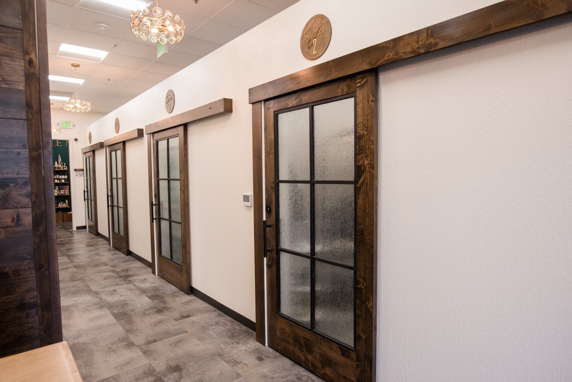 A hallway with sliding glass doors in a building.