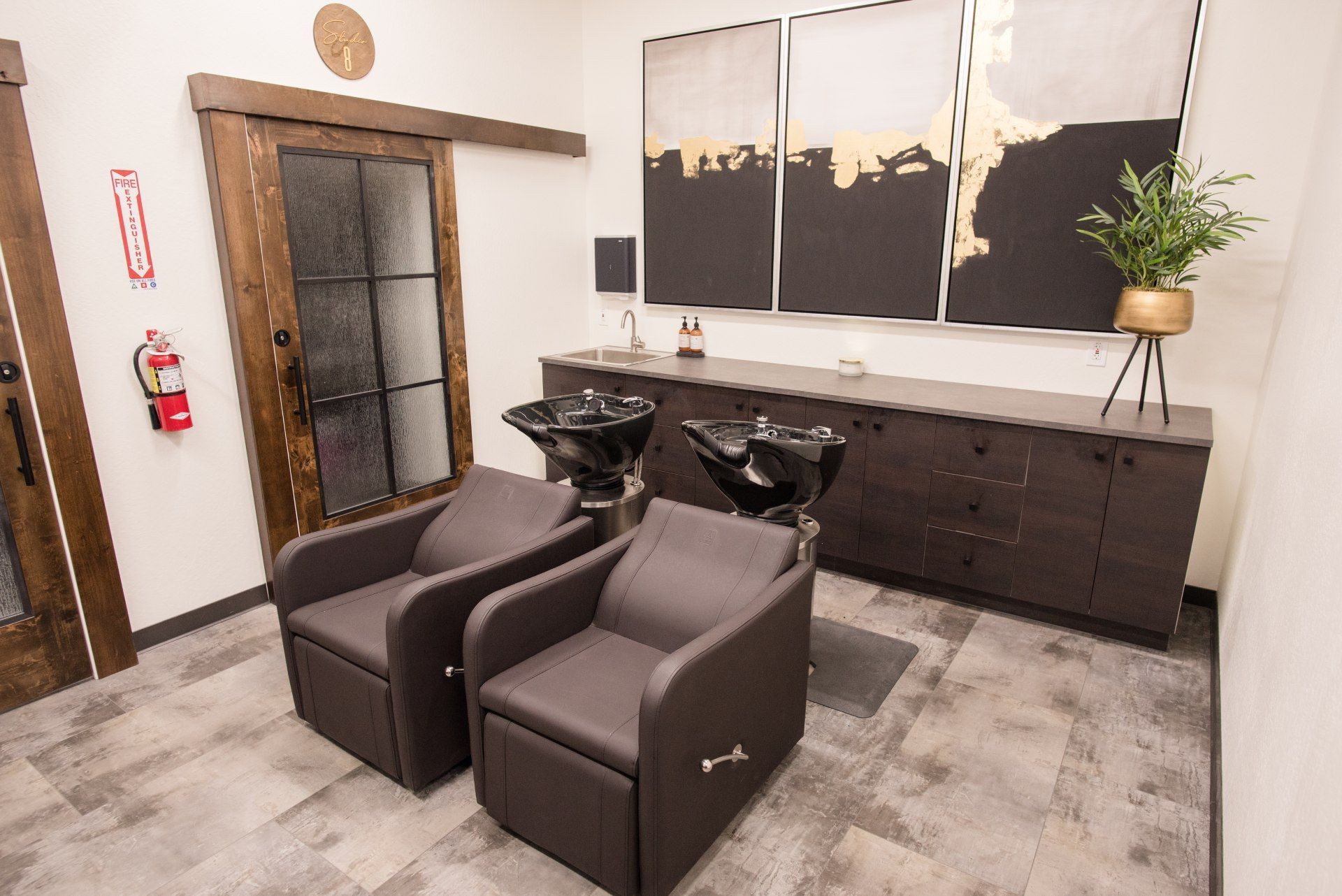 A room with two chairs and a sink in it.