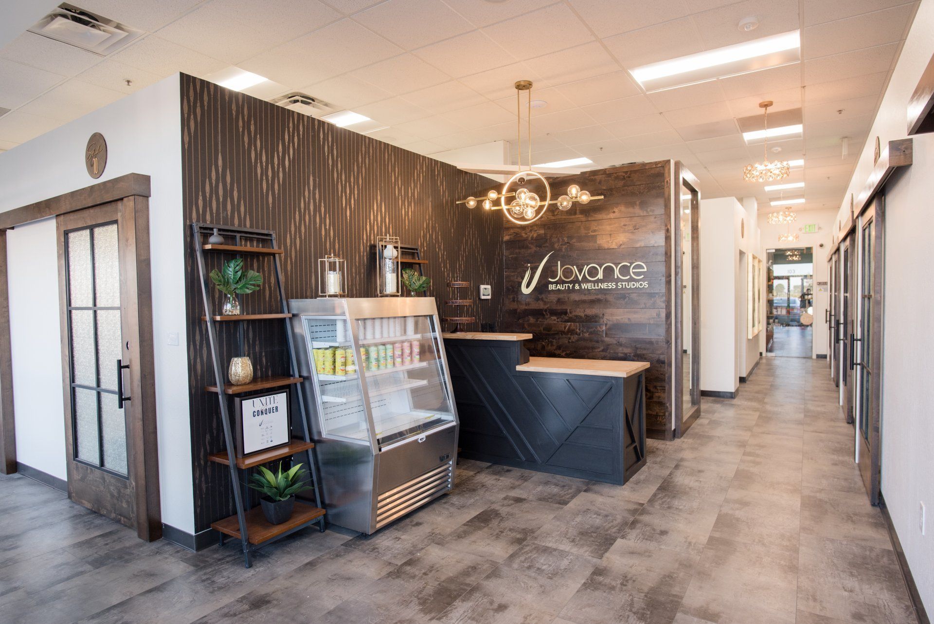 A long hallway with a reception desk and a display case.