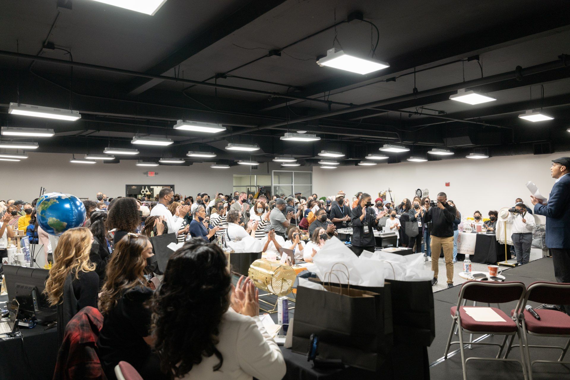 A large group of people are sitting in a large room.