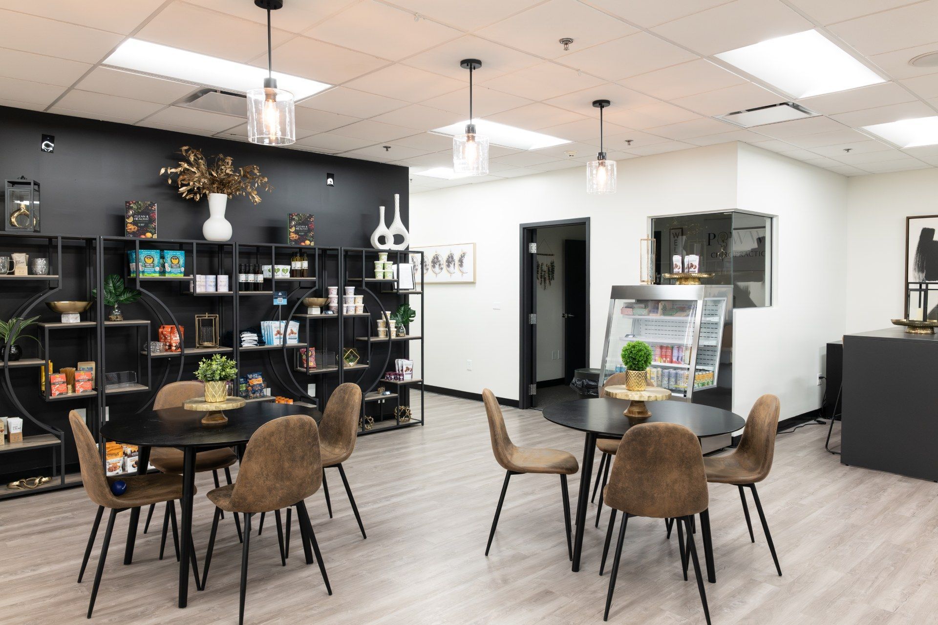 There are many tables and chairs in the room.