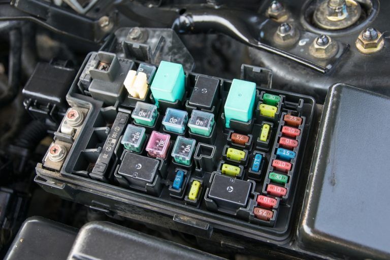 A close up of a fuse box in a car engine - Sean's Auto Care