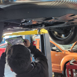 A mechanic performing diagnostics on a car | Sean's Auto Care