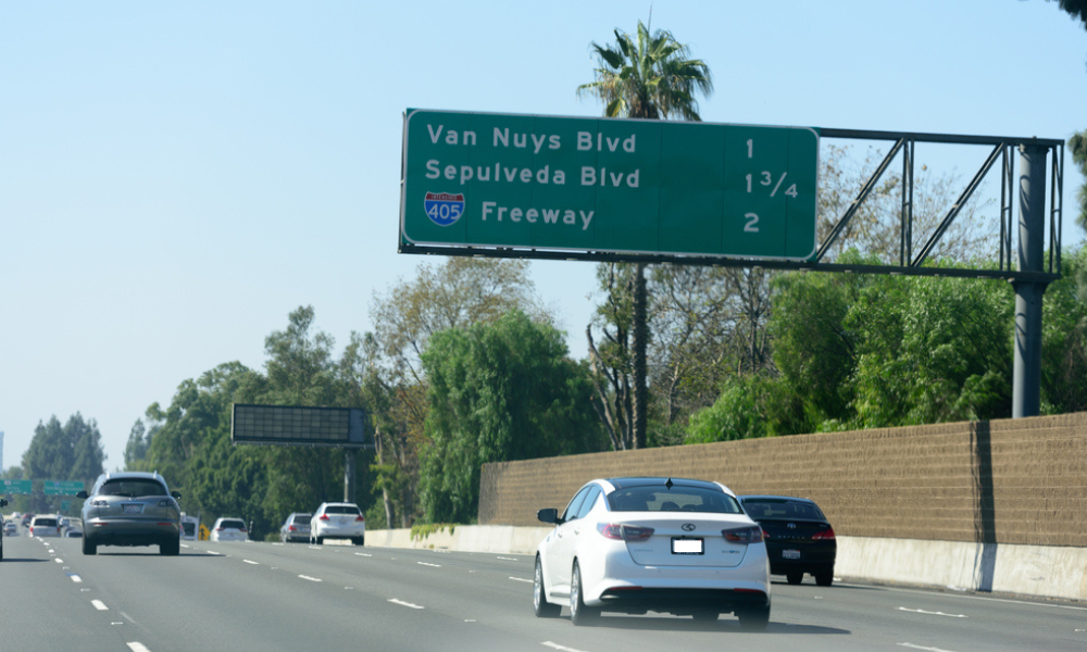 A van nuys blvd sign is above a highway - Sean's Auto Care
