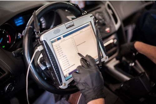 A person is using a tablet in a car - Sean's Auto Care