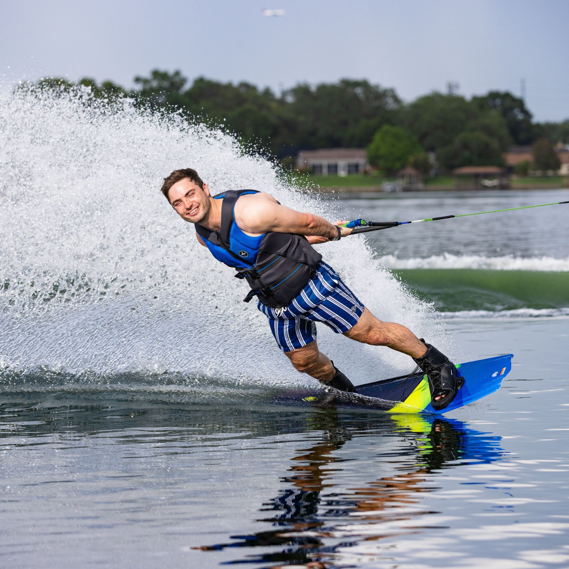 A man is riding a wave on a wakeboard in the water.