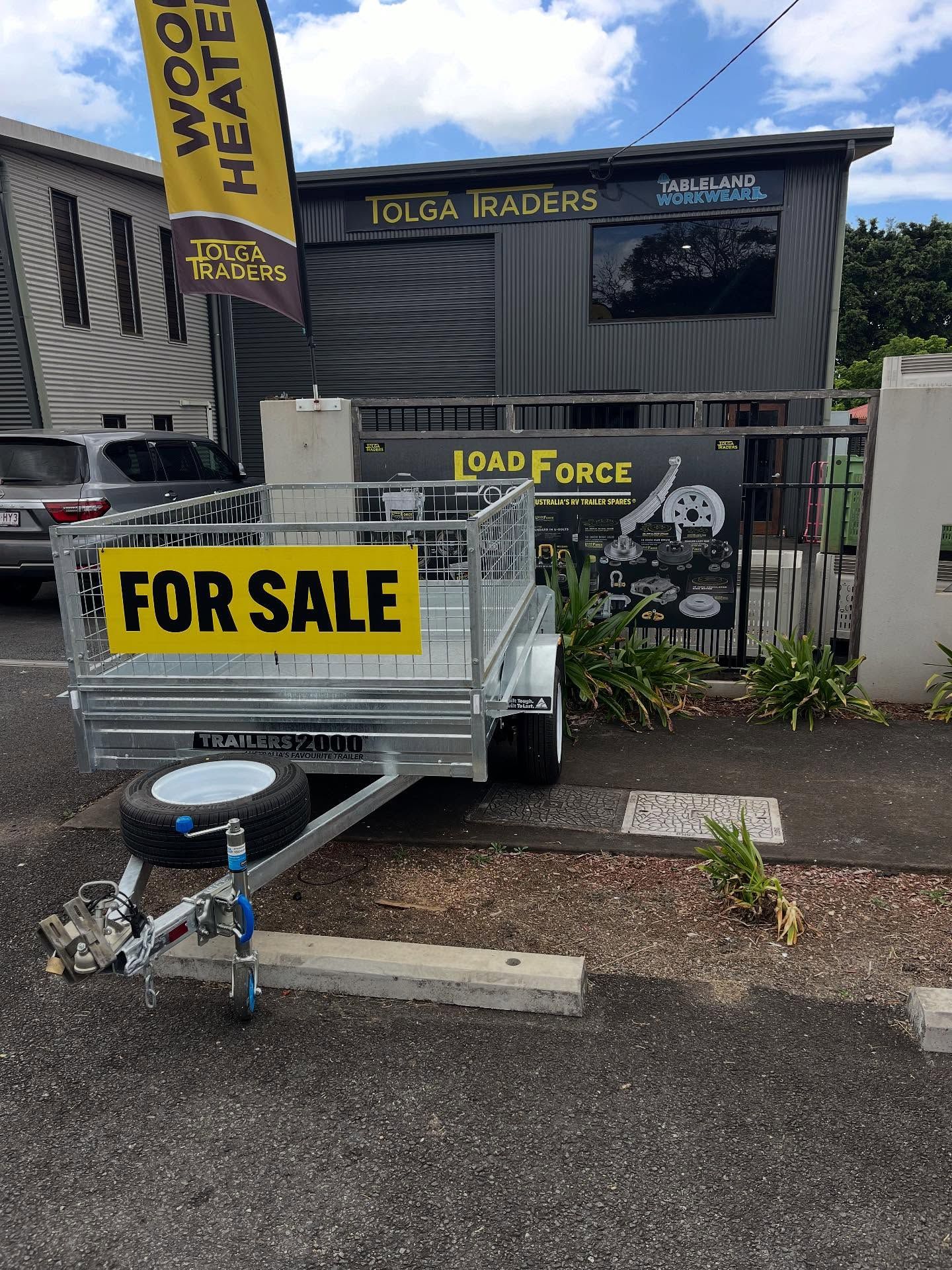 A Trailer for Sale in Front of a Store With a 