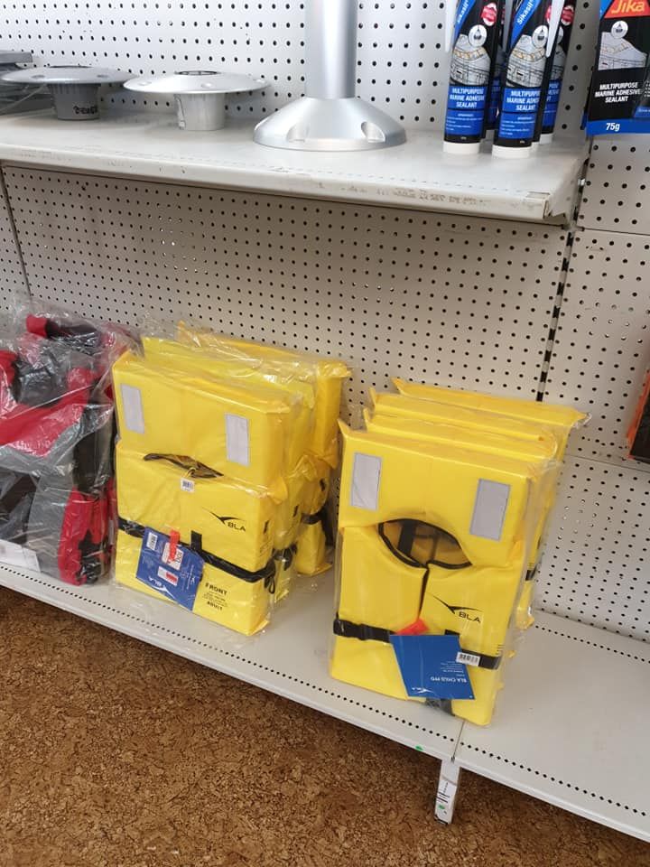 Shelves Stocked With Yellow Life Jackets and Boating Accessories — Tolga Traders in Tolga, QLD