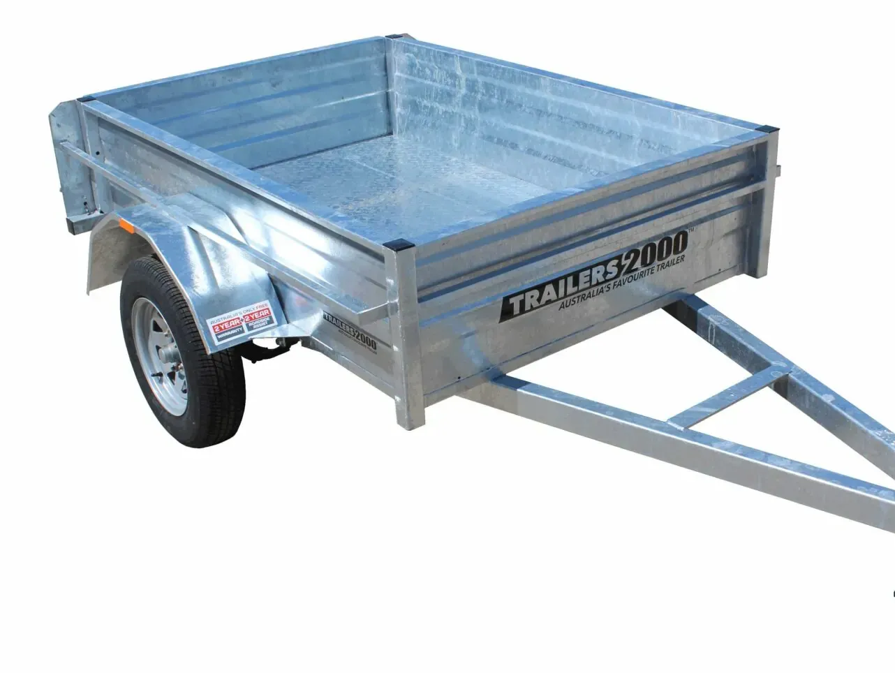 A Trailer is Parked in Front of a Wooden Fence — Tolga Traders in Tolga, QLD Silver utility trailer with black tire and