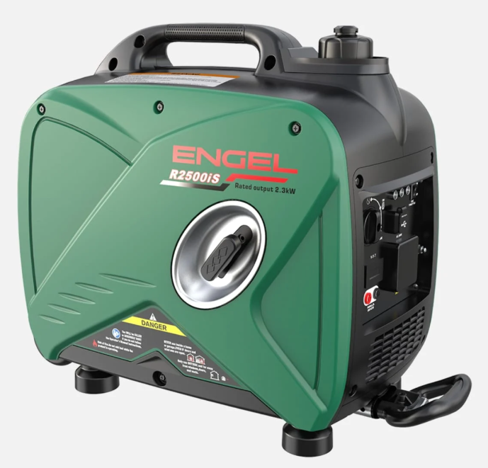 A Red Portable Generator is Sitting in the Grass — Tolga Traders in Tolga, QLD