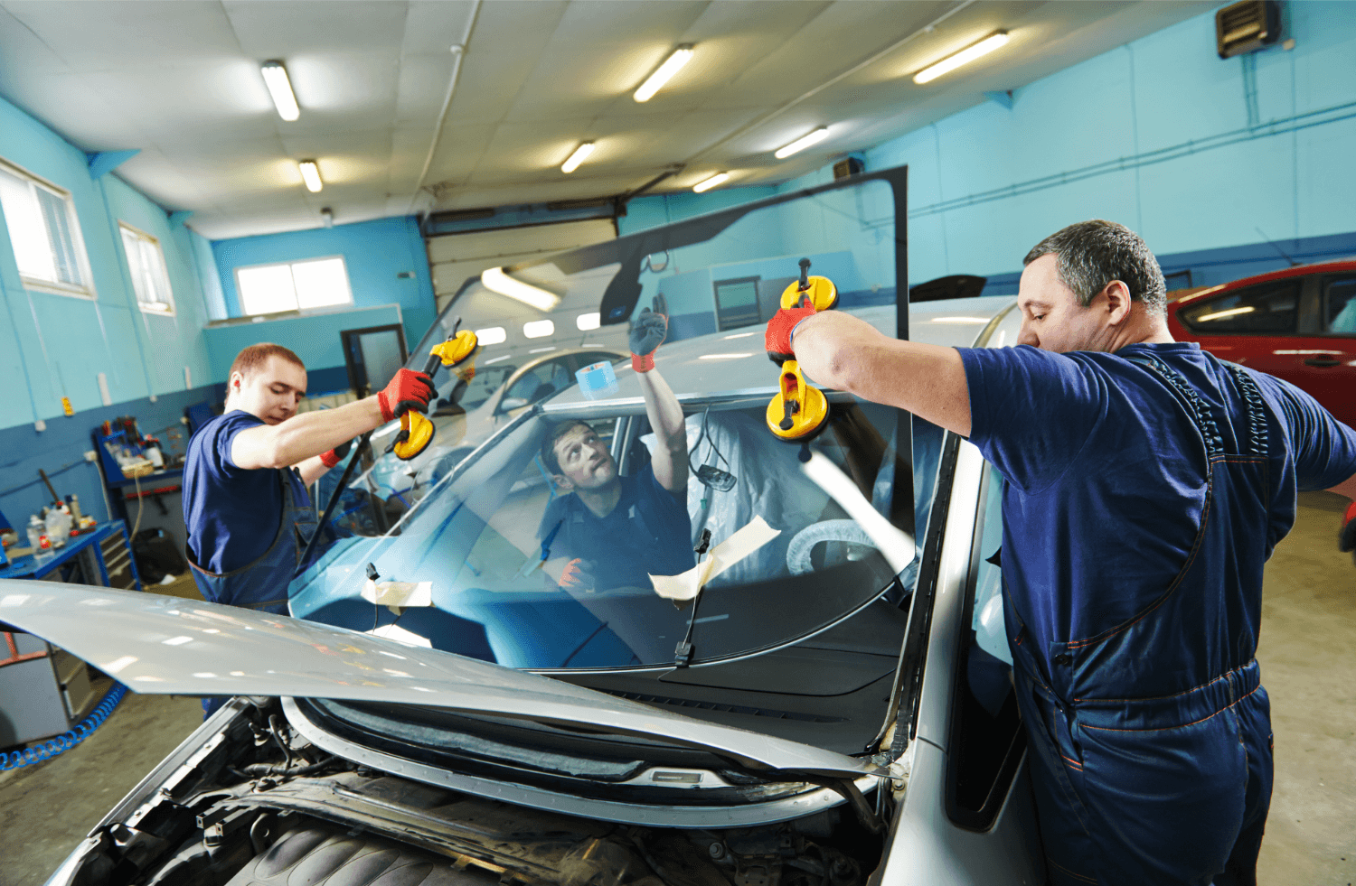 Auto glass specialists replacing a damaged windshield for optimal visibility