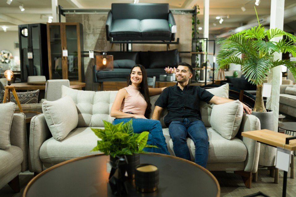 young woman and man buying a sofa