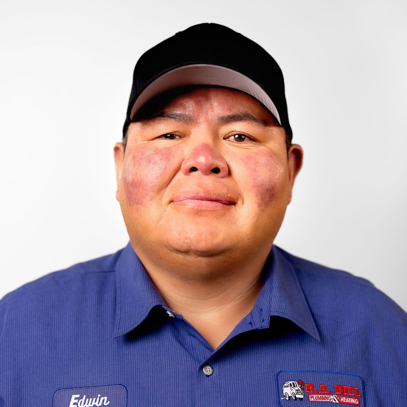 A R.A. Biel, employee smiling at the camera against a white backdrop.