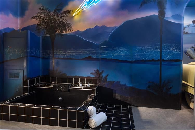 A bathroom with a bathtub and a painting on the wall