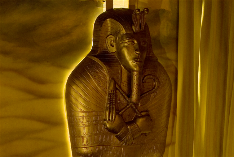 A close up of a statue of a man in a coffin.