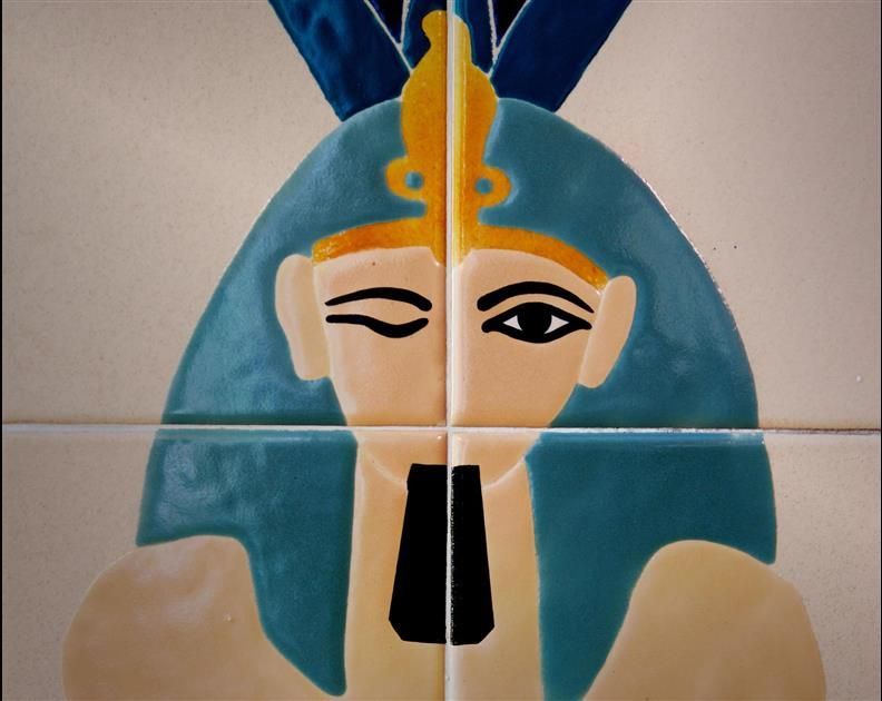 A colorful drawing of a pharaoh 's face with his eyes closed