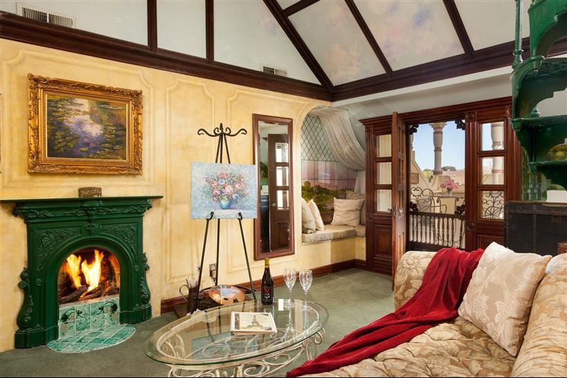 A living room with a fireplace and a painting on the wall