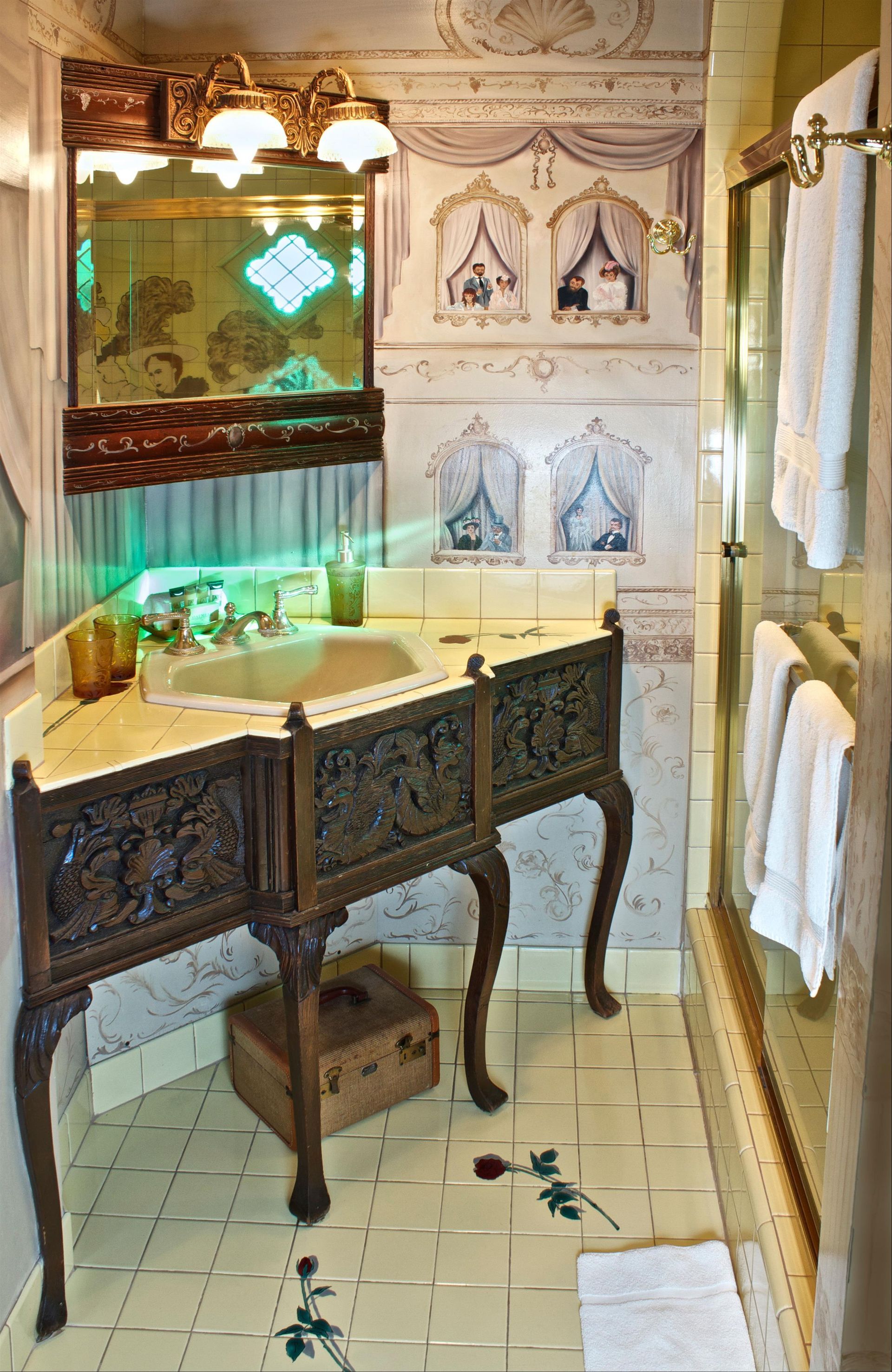 A bathroom with a sink , mirror , and towels.