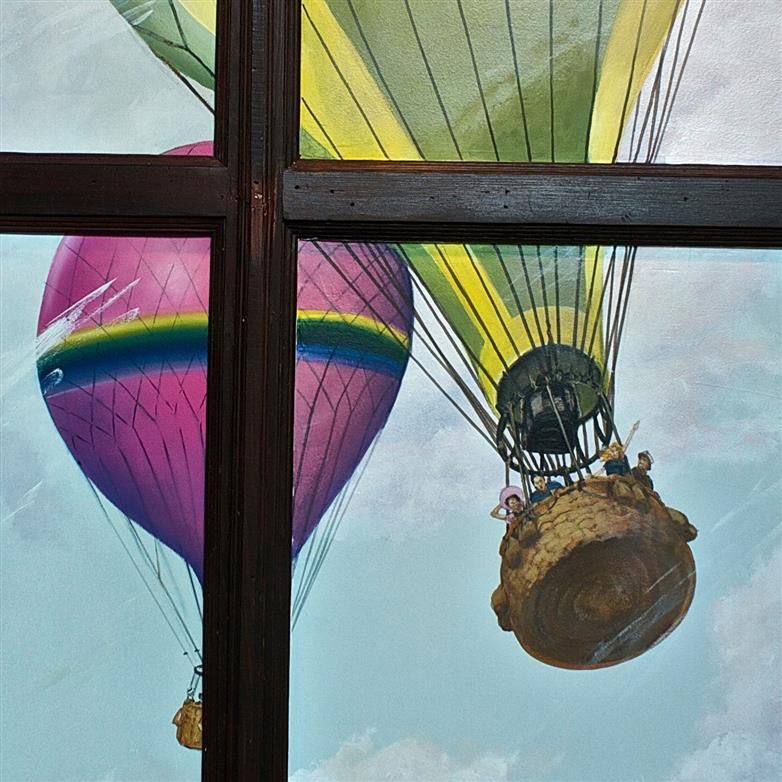 A painting of hot air balloons flying through a window