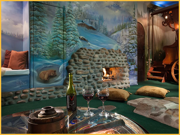 A bottle of wine sits on a table in front of a fireplace.