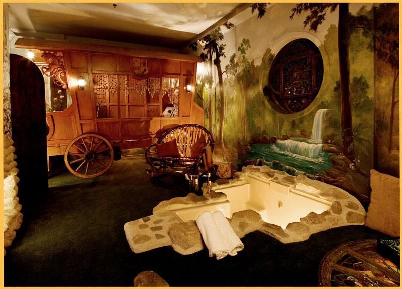 A bathroom with a bathtub and a wagon on the wall