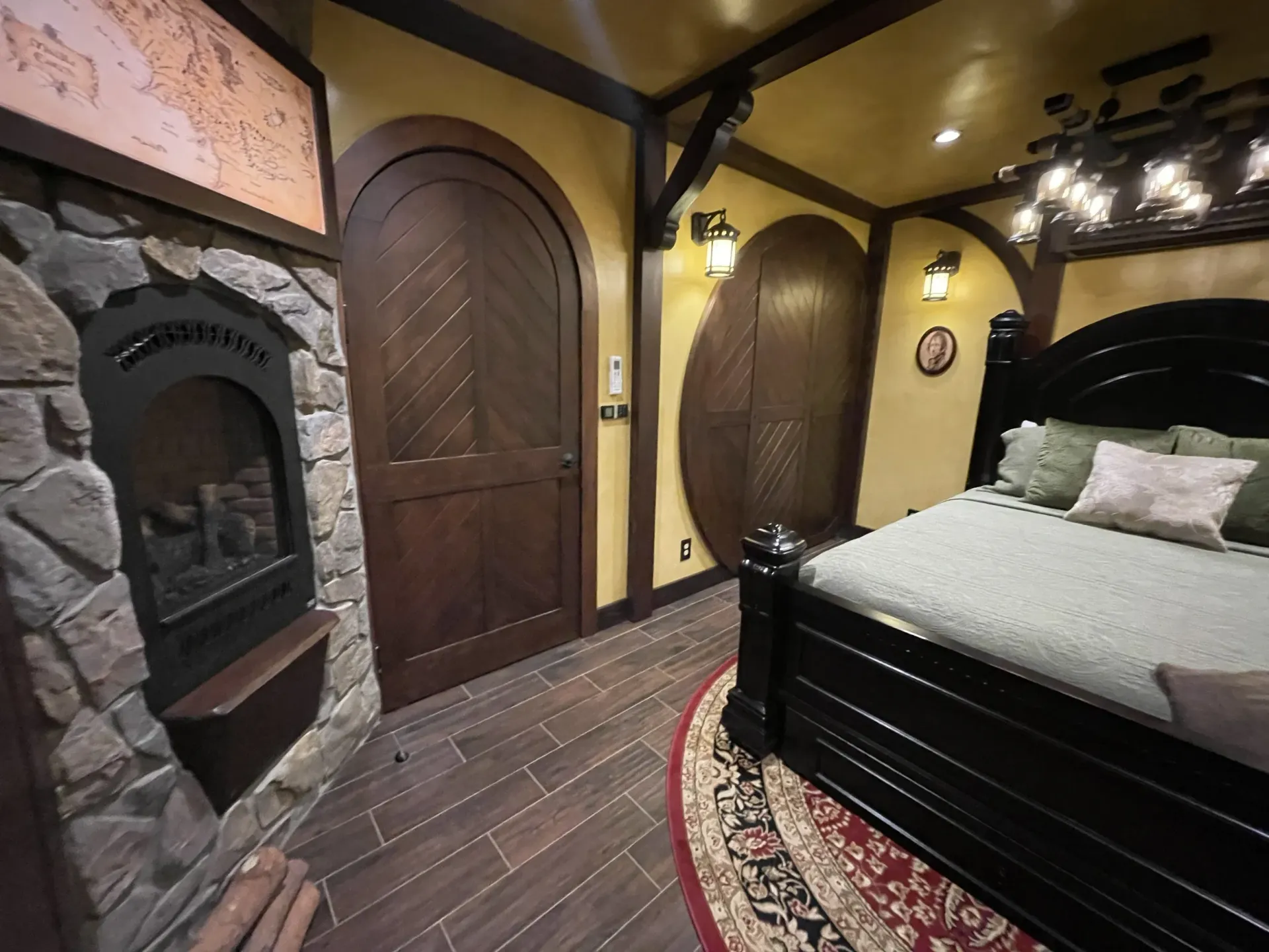 A bedroom with a fireplace and a bed.