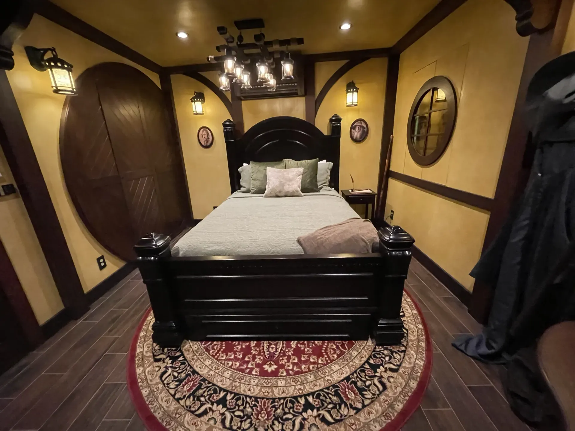 A bedroom with a bed and a rug on the floor