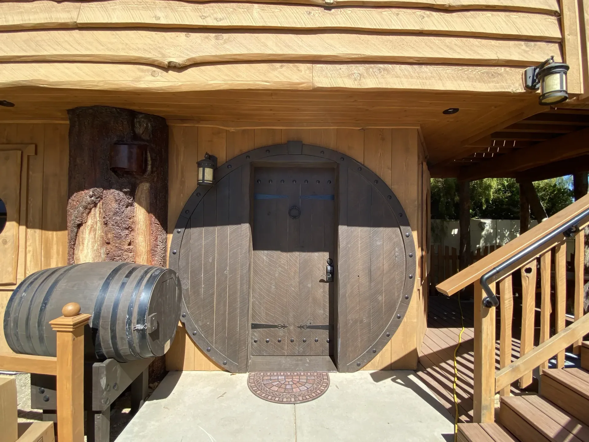 A wooden house with a door that looks like a barrel