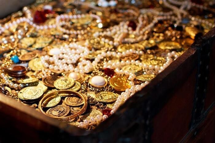 A treasure chest filled with gold coins and pearls.