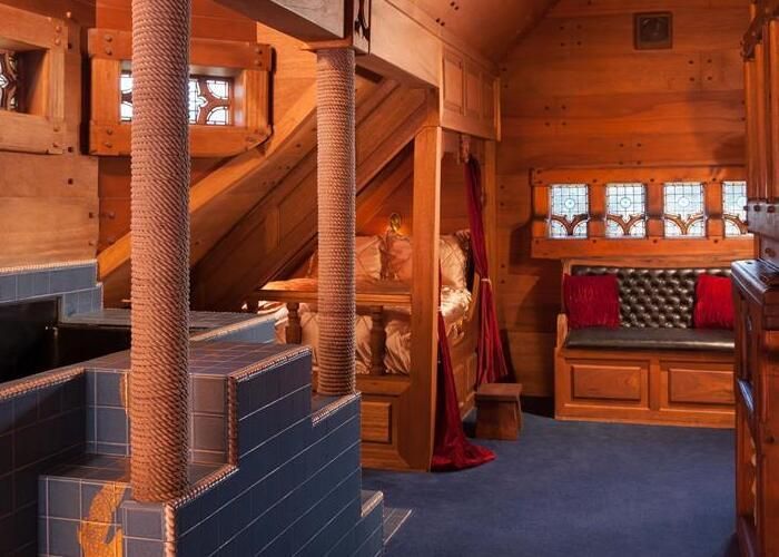 A wooden room with a couch and stairs