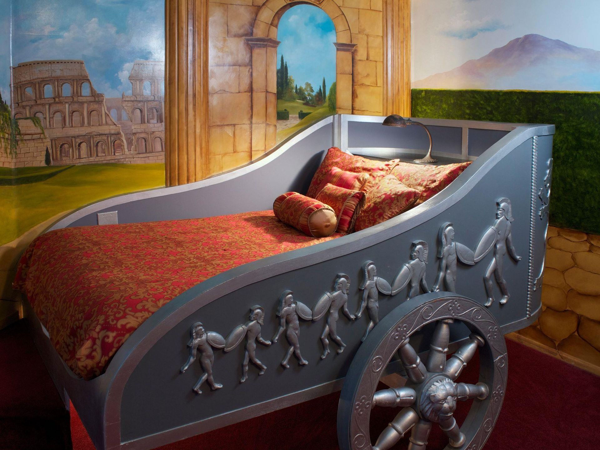 A bed that looks like a chariot with people on it