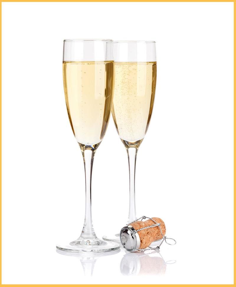 Two glasses of champagne and a cork on a white background.