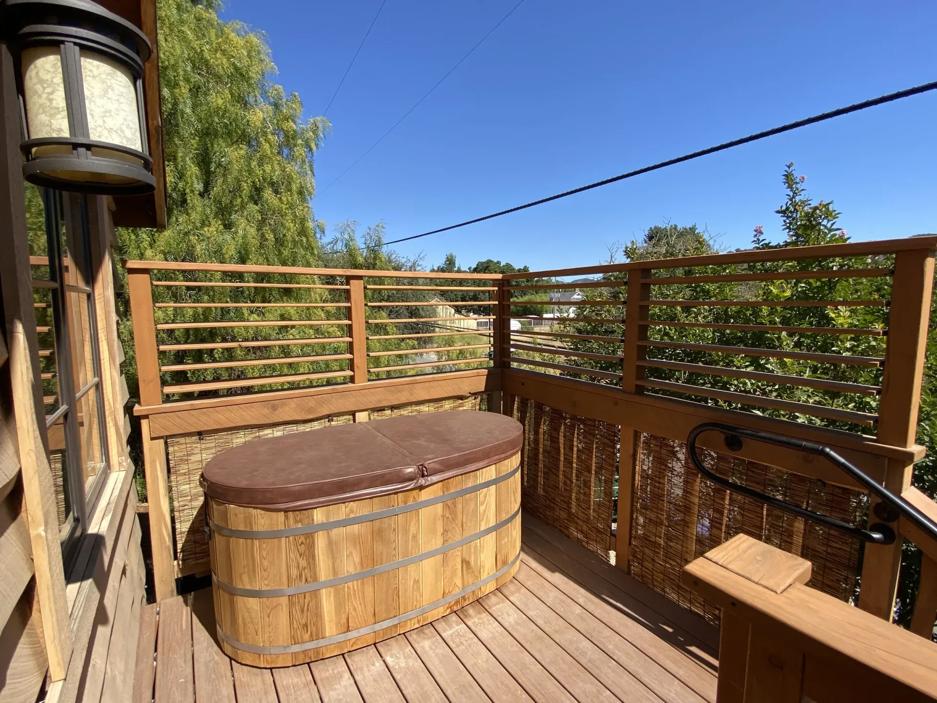 A wooden deck with a wooden tub on it