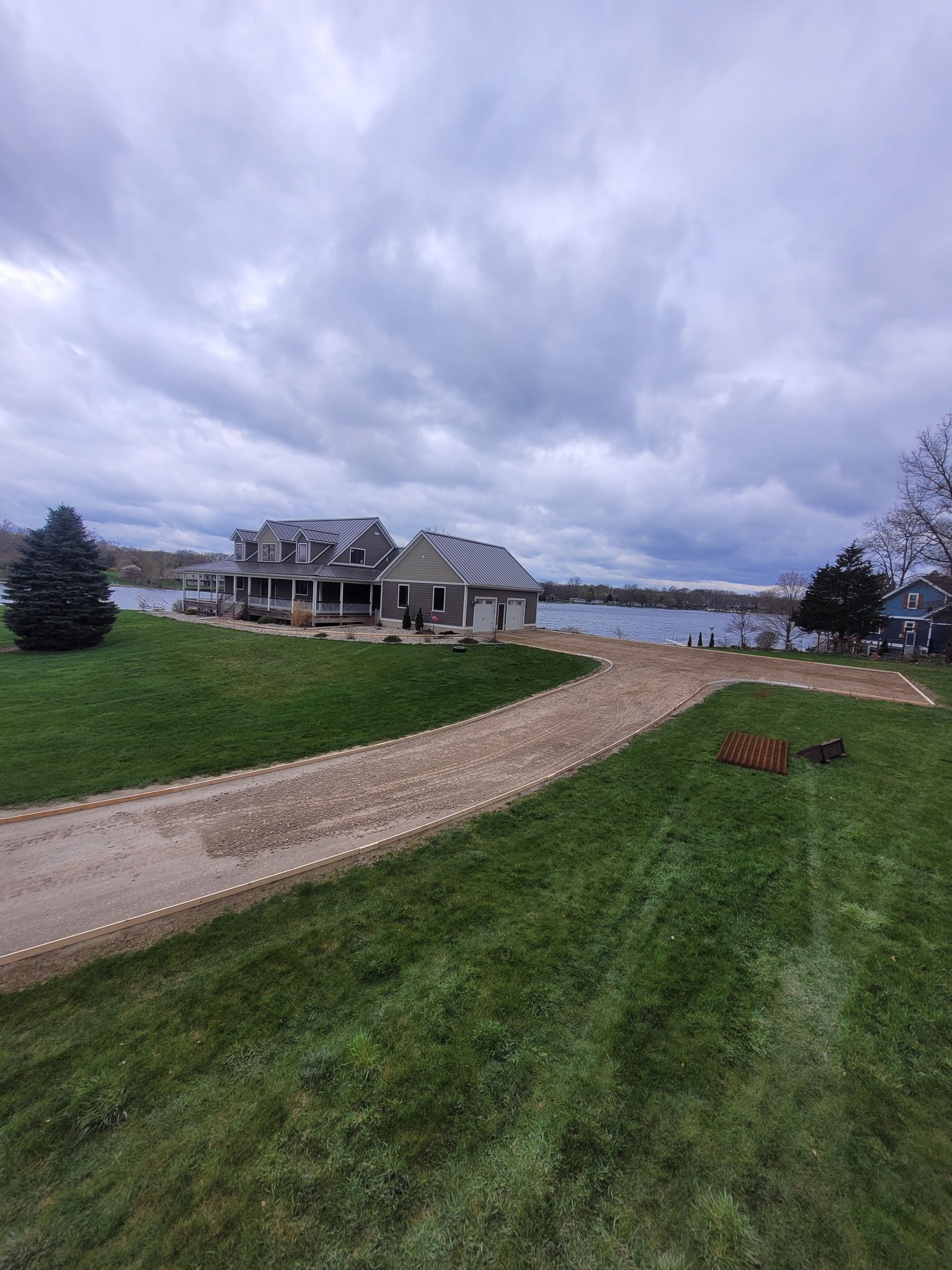 A stone walkway surrounded by flowers and plants in a garden.